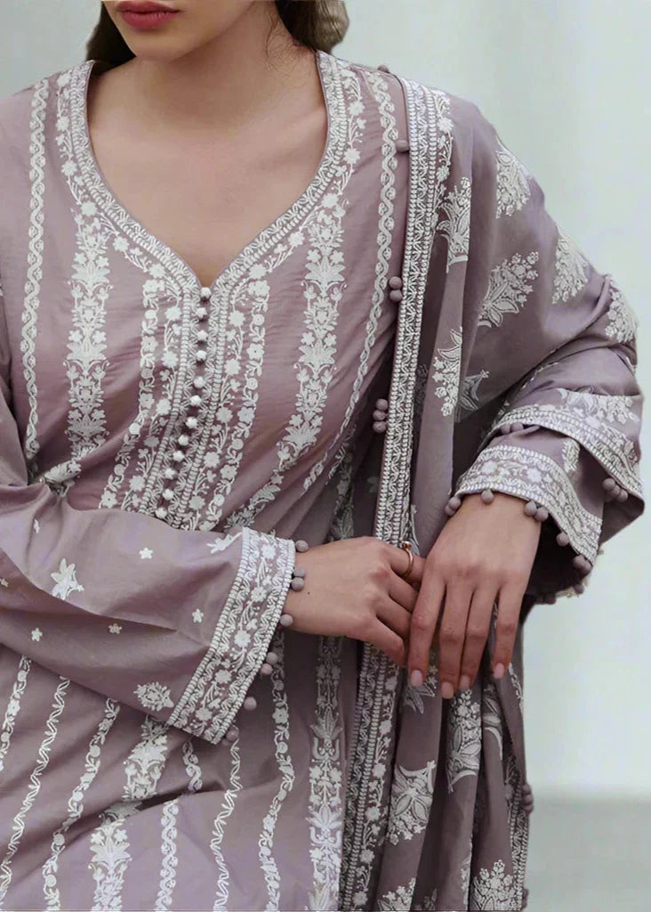 Purple embroidered dress with white patterns on a neutral background