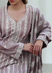 Purple embroidered dress with white patterns on a neutral background